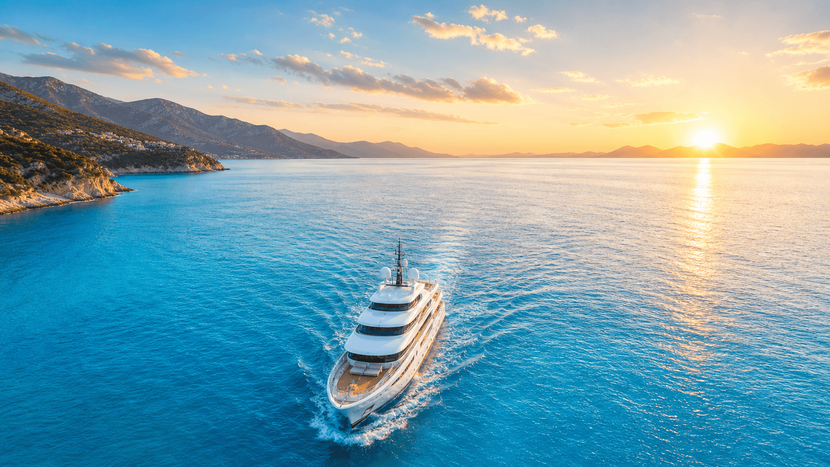 Yacht sailing across the ocean at sunset